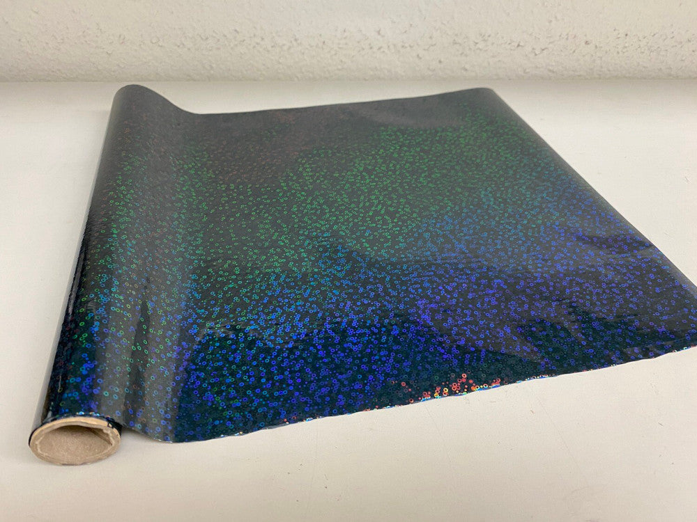 Roll of hot press foil with black background and blue green hologram bubble pattern. Can be used for multiple craft projects.