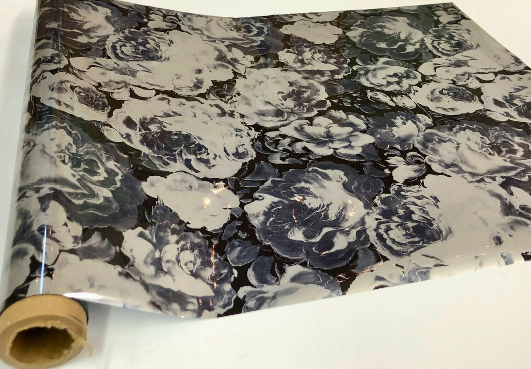 Roll of hot press foil with black background and white and grey flower pattern. Can be used for multiple craft projects.