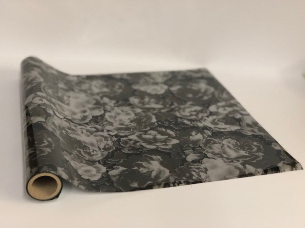 Roll of hot press foil with black background and grey umber color flower pattern. Can be used for multiple craft projects.