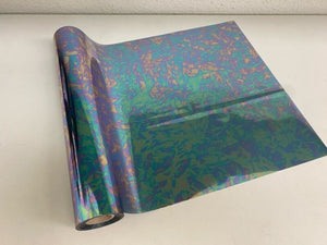 Roll of hot press foil with random green blue and gold melody ocean pattern. Can be used for multiple craft projects.
