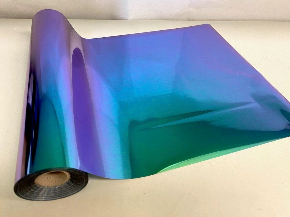 Roll of hot press foil with blue green and purple color shift pattern. Can be used for multiple craft projects.