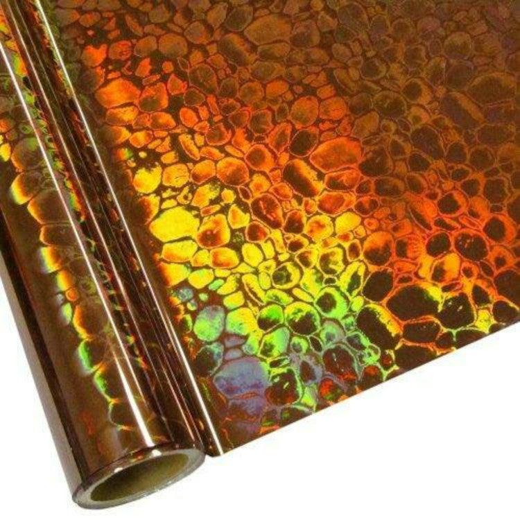 Roll of hot press foil with bronze background and hologram pebble pattern. Can be used for multiple craft projects.